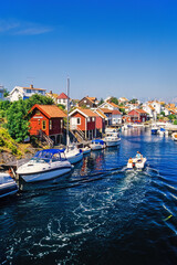 Boats in a sea canal at an old swedish fishing village in the summer