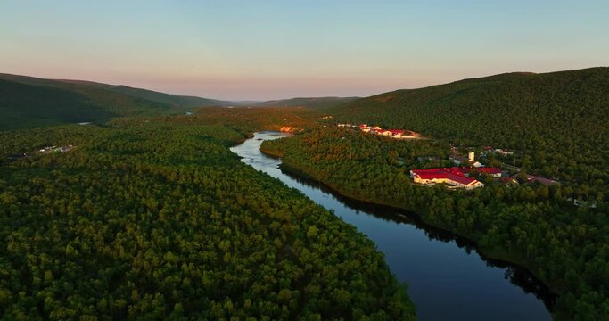 Drone rising along the Stuorraluoppal river, summer sunset in Utsjoki, Finland