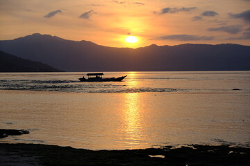 Indonesia Alor Island - Ocean landscape with fishing boat at sunset