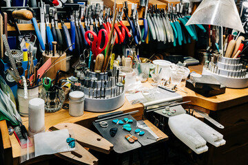 Jewelry makers bench with jewelry making tools and equipment