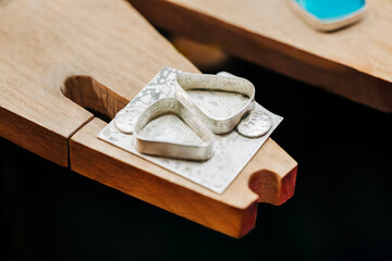 Close up shot of two fine silver earring bezels  on jeweler's bench