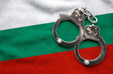 Flag of Bulgaria and police handcuffs. Crime and offenses in country Concept
