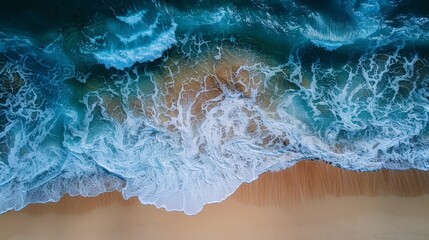 Aerial view of the sea breaking on a sandy beach