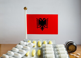 Flag of Albania with Pills and Capsules. Pharmaceutical Concept	

