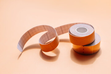 Adhesive tapes for the face in rolls on a yellow background.