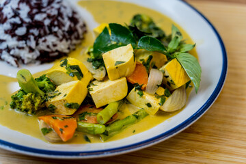 Traditional vegetable green curry with herbs and steamed rice
