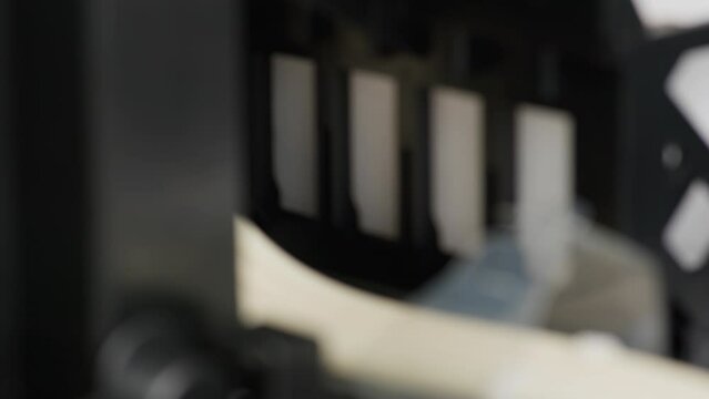 Macro view inside a working inkjet printer, moving gears.
