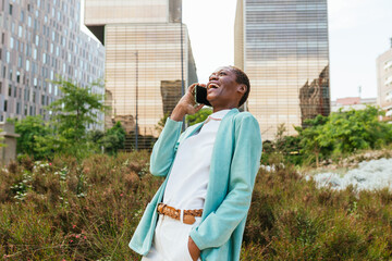 Joyful businesswoman on a phone call outdoors