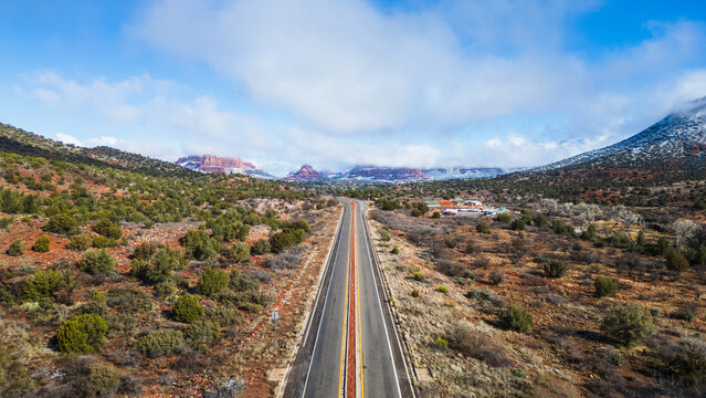 Sedona's red rock vistas on a snowy day, aerial highway view