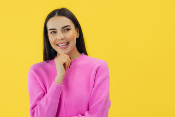 Fototapeta premium Pensive minded woman touch hand chin think thoughts isolated over yellow color background