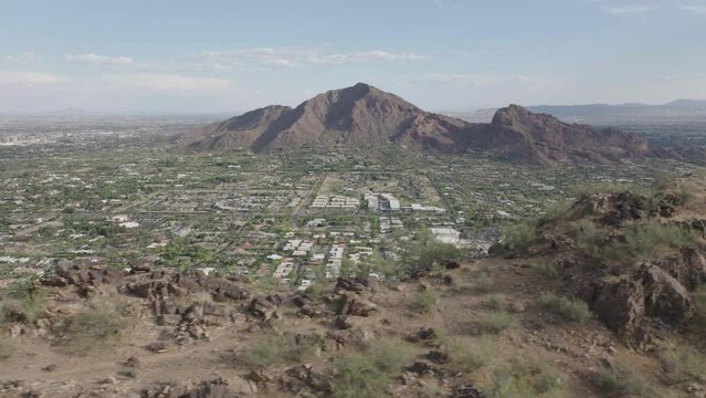 Aerial shot of Mummy mountain and revealing Paradise valley of Arizona in USA and Camelback mountain at background.