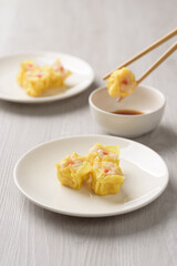 Shrimp shumai, wonton stuffed or dumplings, Asian cultural food on white table background