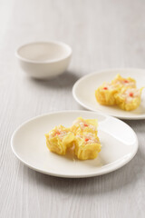 Shrimp shumai, wonton stuffed or dumplings, Asian cultural food on white table background