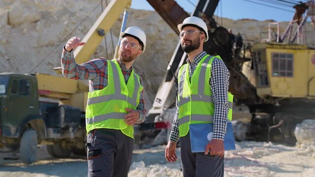 Construction workers engineers are talking at the quarry mining site