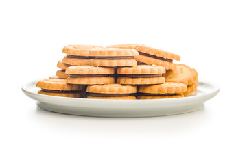 Sandwich Cookies with a cream filling on plate isolated on white background.