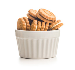 Sandwich Cookies with a cream filling isolated in bowl on white background.