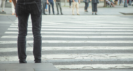 Obraz premium People crossing the zebra on the road.