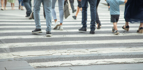 People crossing the zebra on the road.