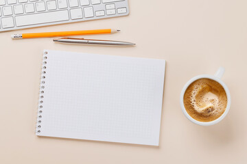 Office desk table with notepad, cup of coffee and supplies