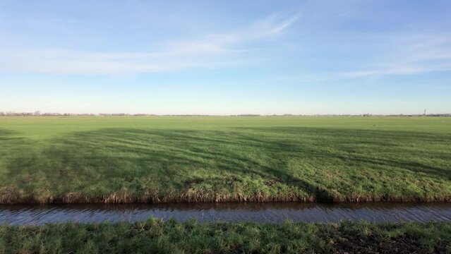 Typical Dutch Landscape With Dikes In The Netherlands. POV Shot