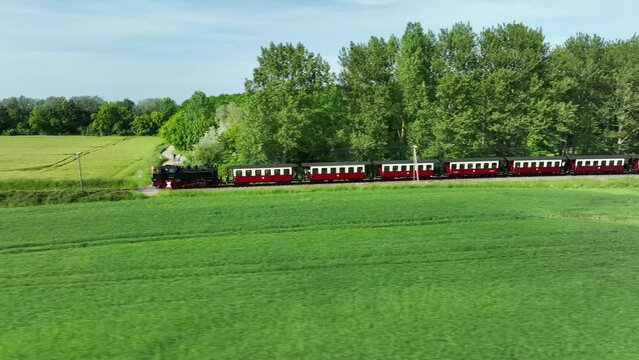 Shot of a steam train moves next to a forest