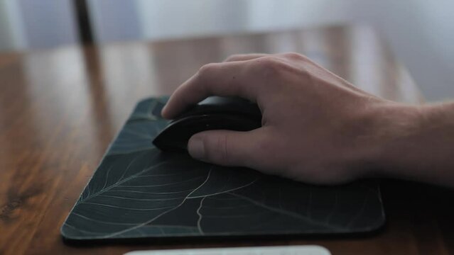 Man hand clicking buttons on pc mouse. Person thinking and working. Close up of pc mouse