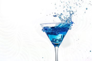 A martini glass filled with a blue curaçao-based cocktail, featuring a mesmerizing blue splash.