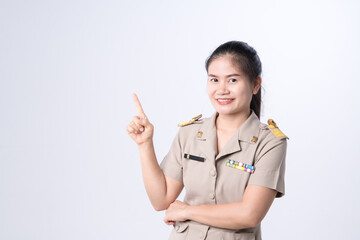 Thai female teachers in official uniform as an officer with pointing finger gesture.