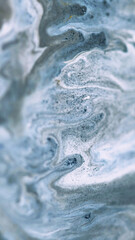Sparkling ink drip. Marble texture. Defocused gray white blue color shiny dust particles acrylic dye paint fluid emulsion liquid wave abstract art background.