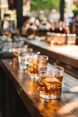 refreshing delights with this cocktail, featuring ice cubes and a citrusy orange wedge, offering a burst of summery flavors.