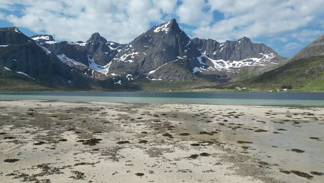 Aerial view over the beautiful Morpheus beach with large snowy mountains. On the Lofoten Islands, Norway.