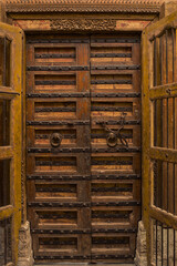 Detailed view of an open old wooden door.