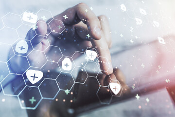 Double exposure of creative abstract medical hologram and finger clicks on a digital tablet on background. Healthcare technolody concept