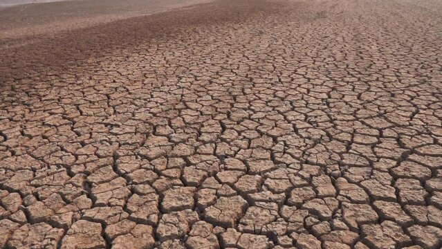 Draught land of Kutch desert. Natural pattern of desert land. Cracked, dry soil due to lack of water and hot weather in Little Rann of Kutch, Gujarat. Dehydrated and barren land during summer season