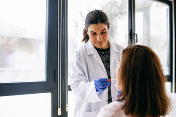 Doctor taking swab from the patient's mouth