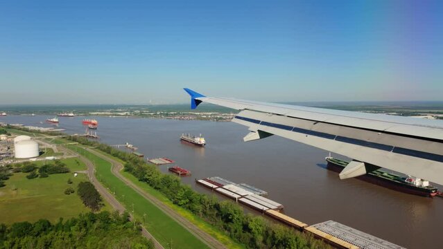 Louis Armstrong New Orleans International Airport MSY wide view from the porthole of the landing airplane
