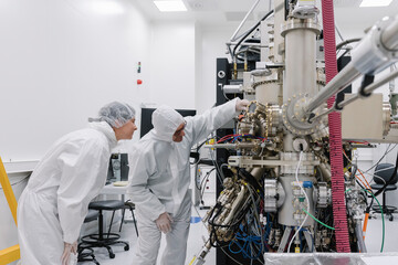 Laboratory technicians working on a device in laboratory of science center