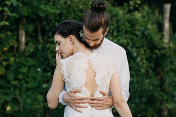 Bride and groom embracing outdoors