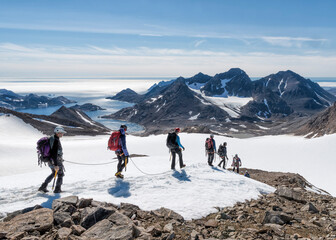 Greenland, Sermersooq, Kulusuk, Schweizerland Alps, group of people walking in snow © tunedin