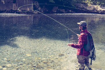 Slovenia, man fly fishing in Soca river