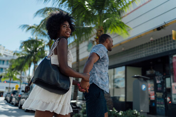 USA, Florida, Miami Beach, happy young couple crossing the street