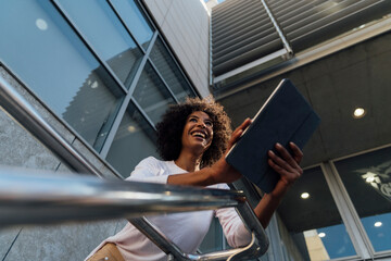 Young casual businesswoman using smartphone