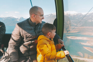 Father and son in the gondola of a cable car, Squamish, Canada © tunedin