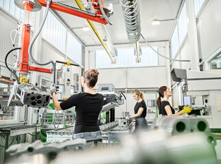 Three women working on machines