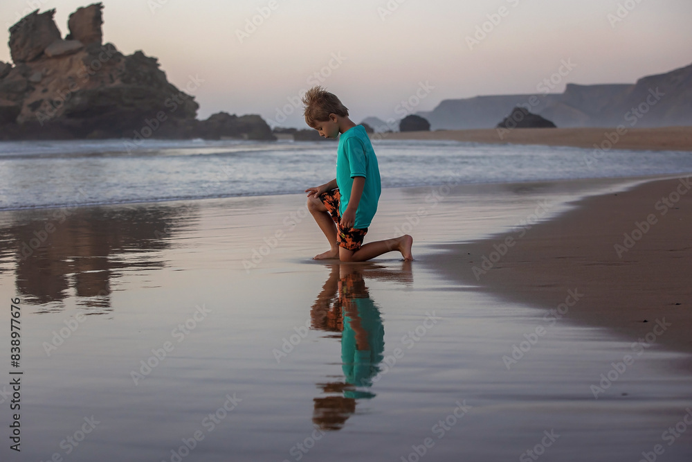 Canvas Prints Happy children, boys, playing on the beach on sunset, kid cover in sand, smiling, laughing