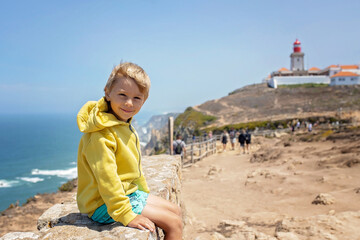 Family with children, siblings, visiting the most west point of Europe, Cabo Da Roca, during family...
