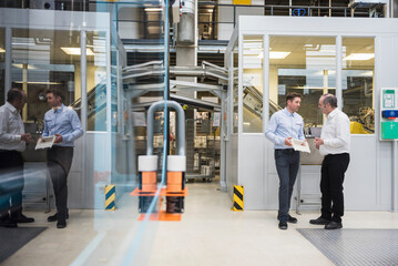 Two men talking in factory shop floor