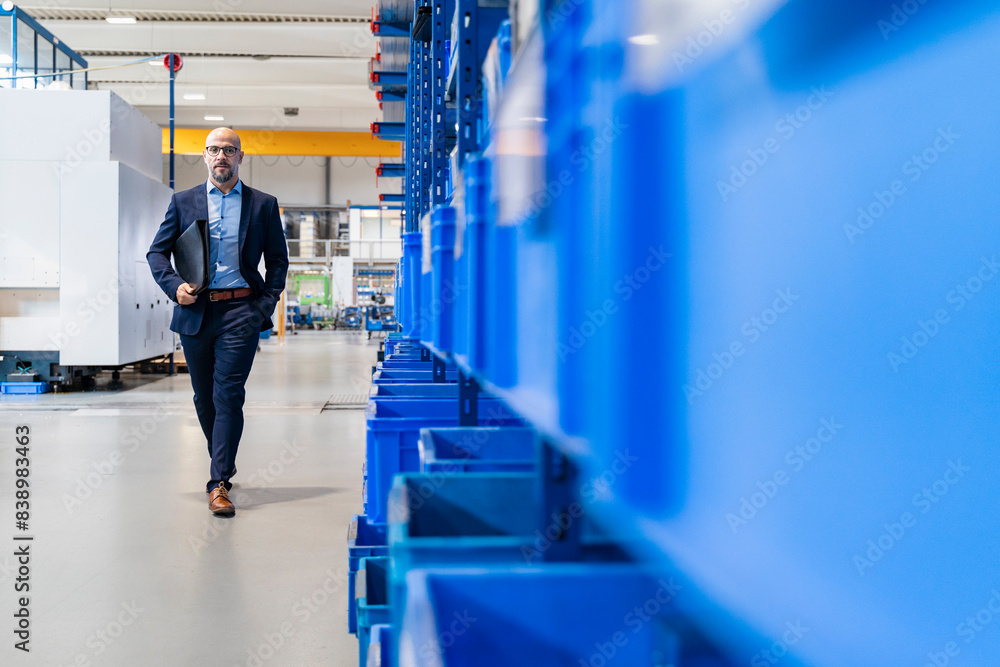 Canvas Prints Businessman with folder walking in factory