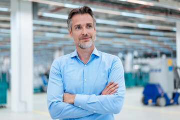 Portrait of confident businessman in a factory hall