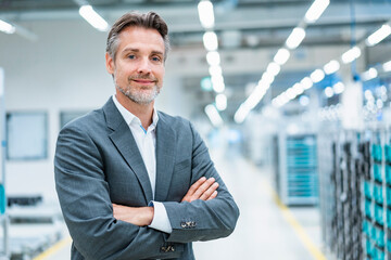 Portrait of a confident businessman in a modern factory